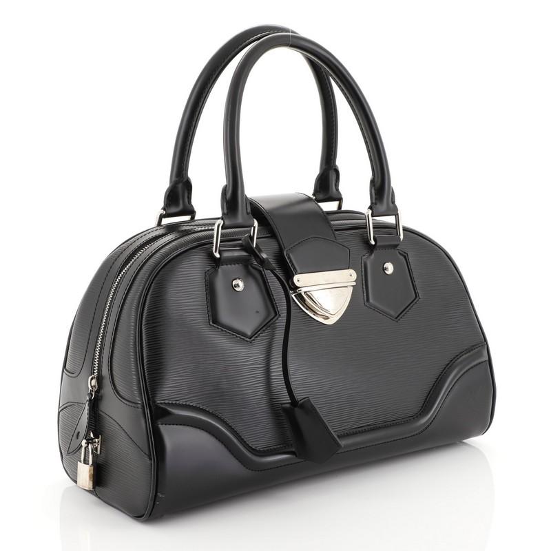 This Louis Vuitton Montaigne Bowling Bag Epi Leather GM, crafted from black epi leather, features dual rolled leather handles, protective base studs and silver-tone hardware. Its slide-lock and zip closure opens to a black fabric interior with slip