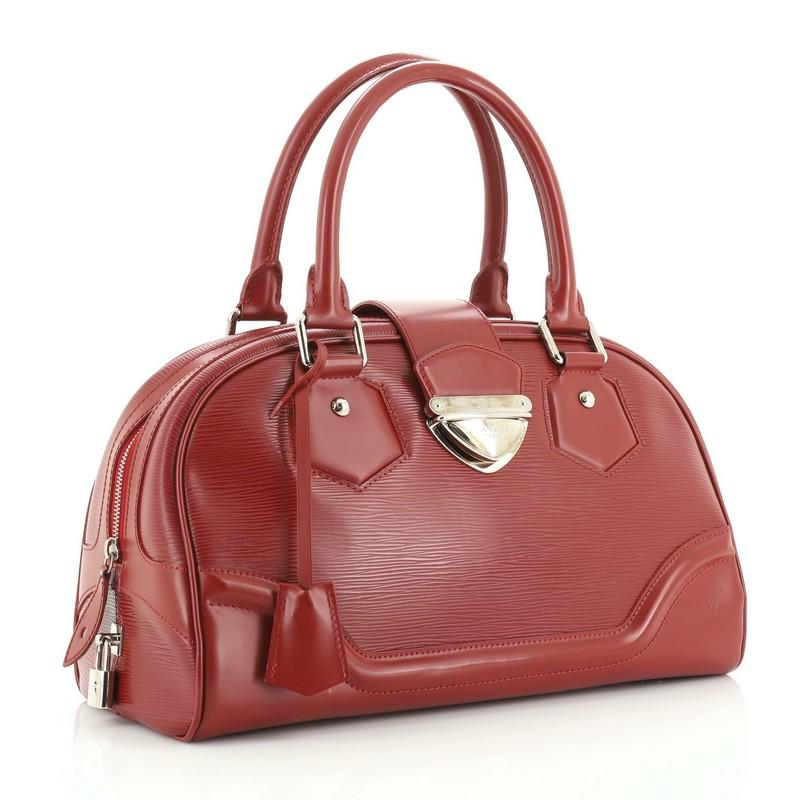 This Louis Vuitton Montaigne Bowling Bag Epi Leather GM, crafted from red epi leather, features dual rolled leather handles, protective base studs and silver-tone hardware. Its slide-lock and zip closure opens to a red fabric interior with slip