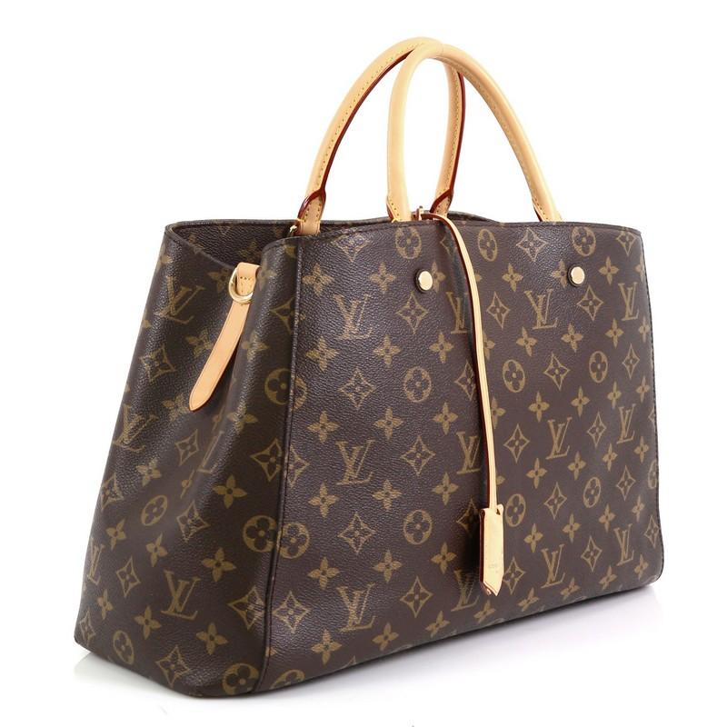 This Louis Vuitton Montaigne Handbag Monogram Canvas GM, crafted from brown monogram coated canvas, features dual rolled vachetta leather handles, and gold-tone hardware. Its hook closure opens to a purple microfiber interior with middle zip
