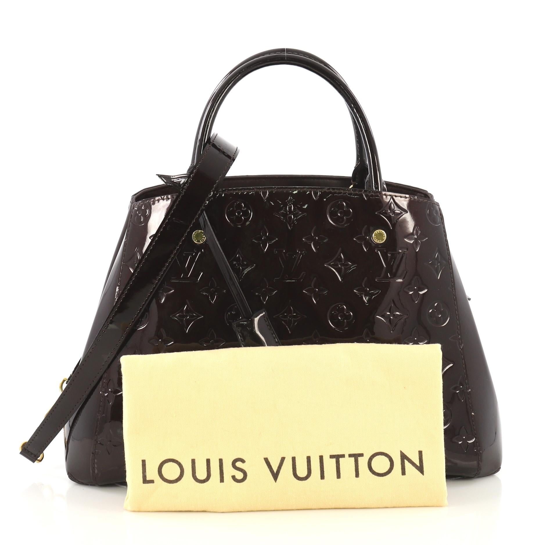This Louis Vuitton Montaigne Handbag Monogram Vernis MM, crafted from purple monogram vernis leather, features dual rolled handles, protective base studs, and gold-tone hardware. Its hook clasp closure opens to a purple fabric interior divided into