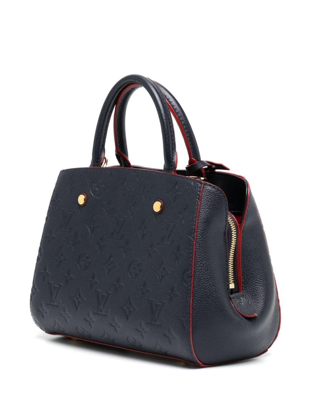 The Montaigne MM is crafted from Louis Vuitton's signature Monogram in navy blue leather. It exudes sophistication and is designed to withstand the test of time. The bag features a structured and spacious silhouette, making it suitable for