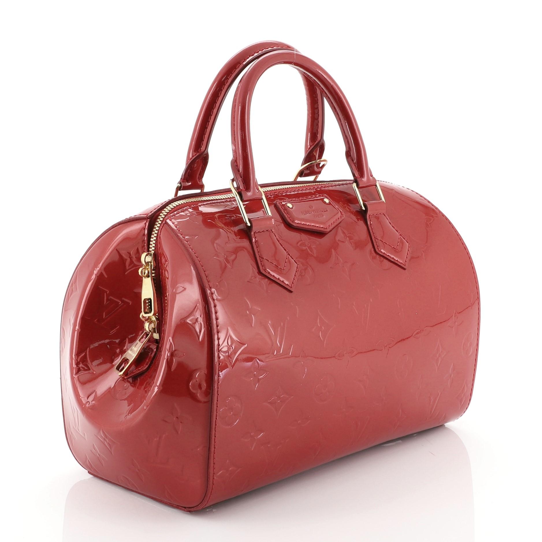 This Louis Vuitton Montana Handbag Monogram Vernis, crafted in red monogram vernis leather, features dual rolled handles, protective base studs and gold-tone hardware. Its zip closure opens to a red fabric interior with slip pocket. Authenticity