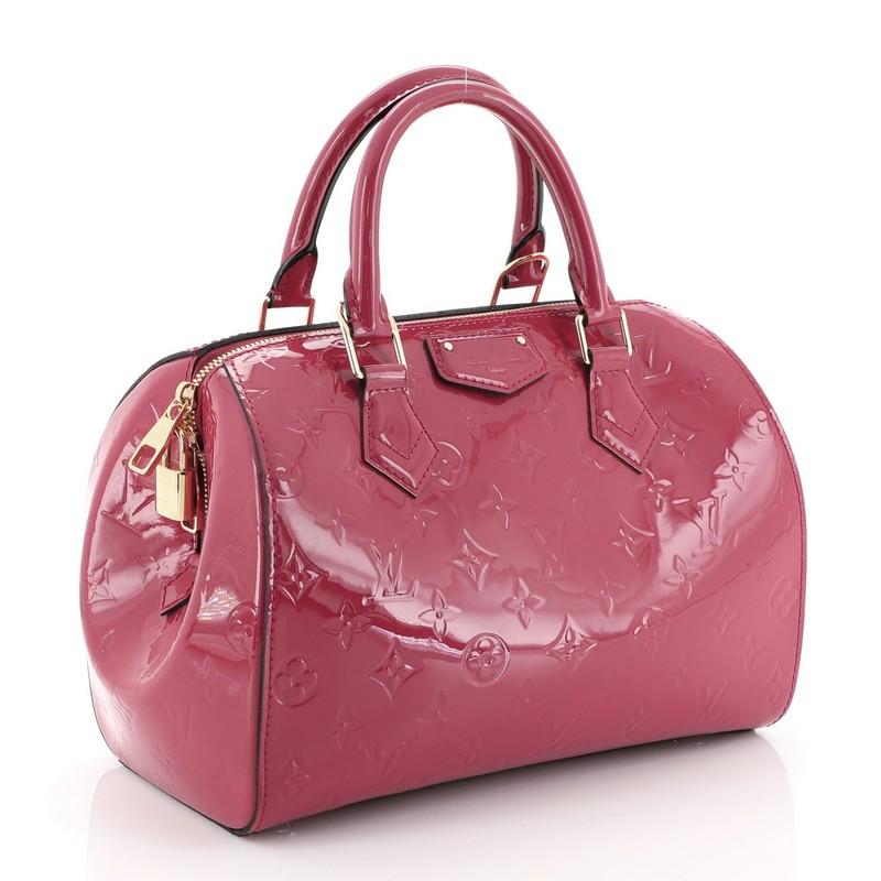 This Louis Vuitton Montana Handbag Monogram Vernis, crafted in pink monogram vernis leather, features dual rolled handles, protective base studs and gold-tone hardware. Its zip closure opens to a pink fabric interior with slip pocket. Authenticity