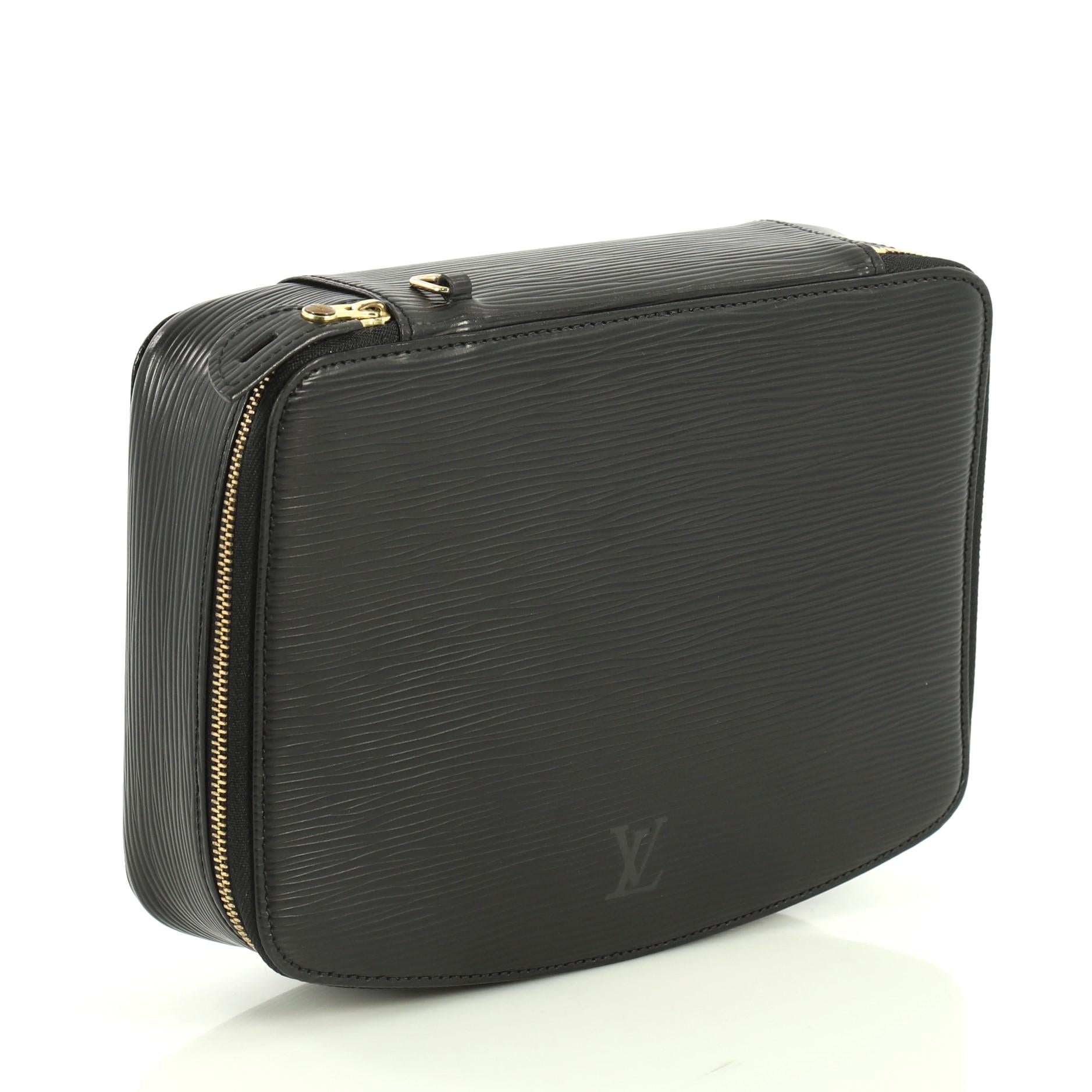 This Louis Vuitton Monte-Carlo Jewelry Box Epi Leather, crafted from black epi leather, features gold-tone hardware. Its zip-around closure opens to a gray microfiber interior with multiple pouch zip pockets. Authenticity code reads: MI0967.