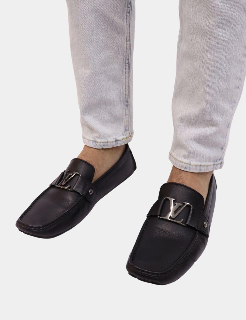 Refined and versatile, these Louis Vuitton Monte Carlo Loafers in smooth black leather are a staple for the modern gentleman. Featuring a sleek square toe and a polished silver-tone LV buckle, these moccasin-style loafers offer luxury comfort with