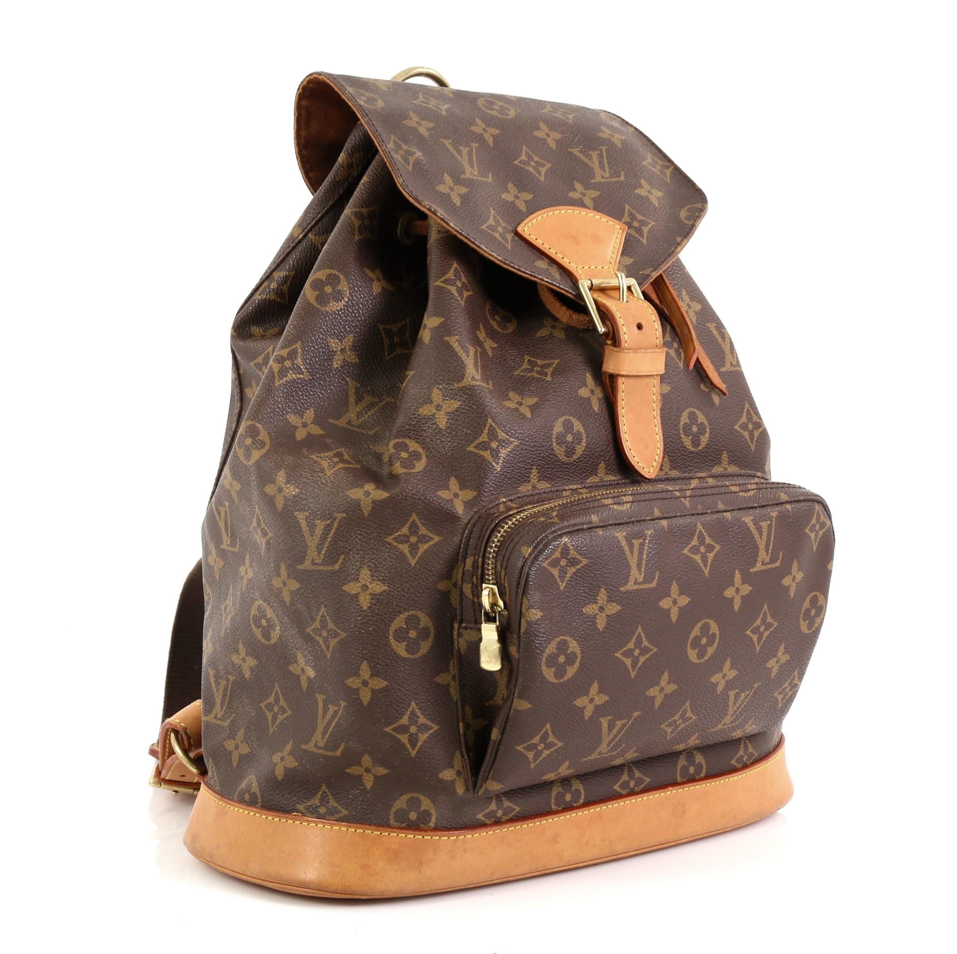 This Louis Vuitton Montsouris Backpack Monogram Canvas GM, crafted from brown monogram coated canvas, features adjustable canvas straps, cowhide leather base, exterior front zip pocket and gold-tone hardware. Its flap top frontal buckle and
