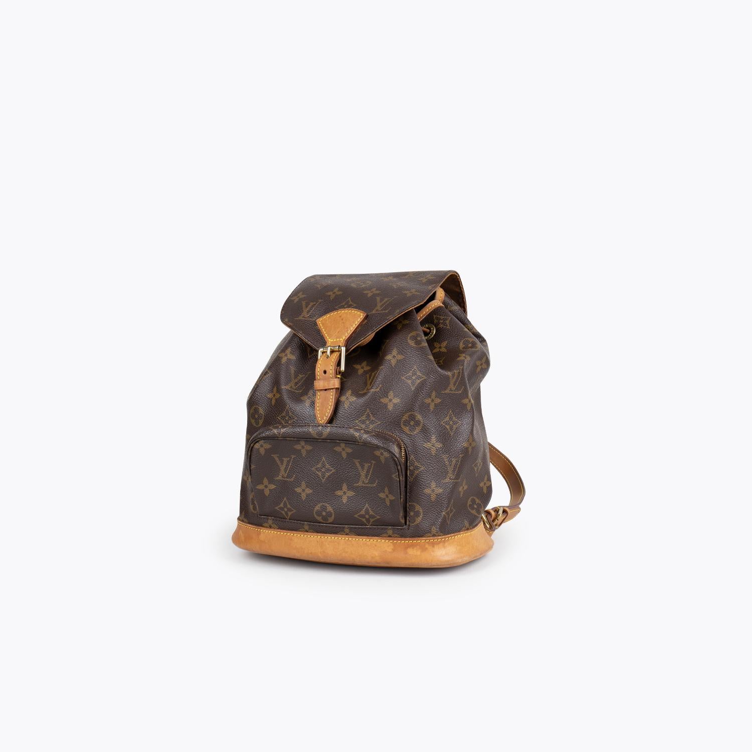 Brown and tan monogram coated canvas Louis Vuitton Montsouris MM with

- Brass-tone hardware
- Tan Vachetta leather trim
- Single rolled top metal handle
- Dual flat shoulder straps with buckle adjustment, single exterior zip pocket, brown canvas