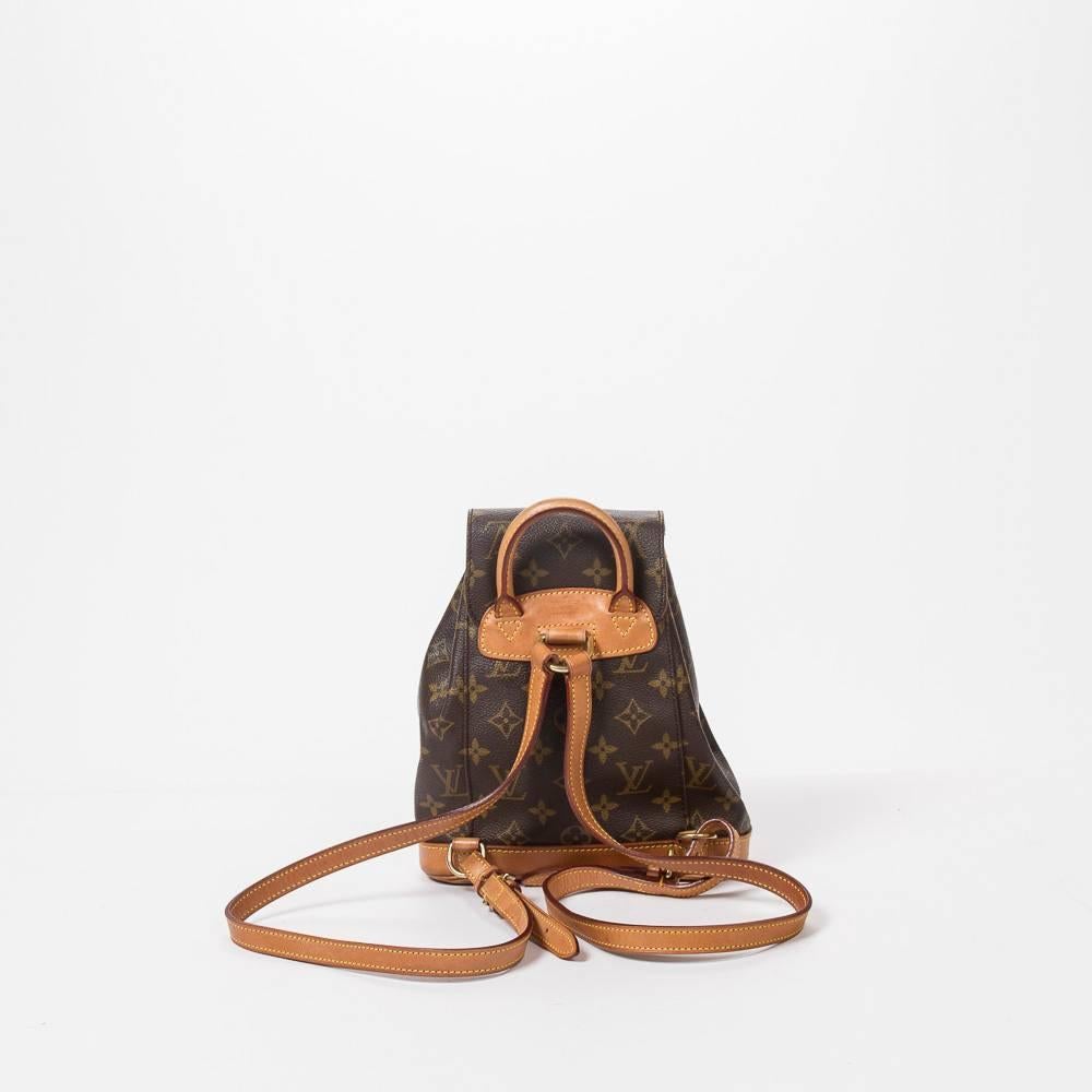 Montsouris PM in monogram canvas with vachetta leather base and details, adjustable canvas straps and golden brass tone hardware. 1 front zip pocket. Drawstring and buckle closure. Brown fabric lined interior with 1 slip pocket. Signed 