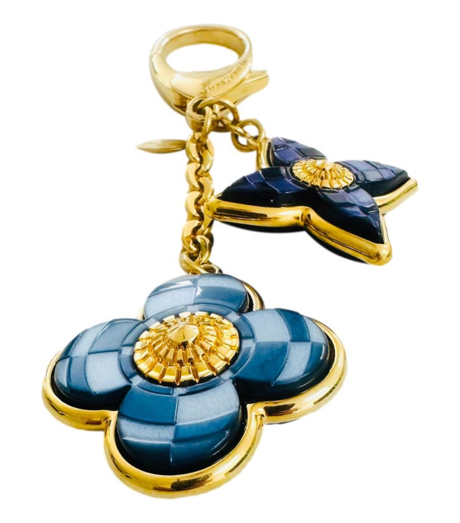 Louis Vuitton Mosaique Bag Charm

The brand’s signature blooming flowers emblems in blue with mosaic detailing set on a gold base with decorative gold centre.

Linked with gold chain with D-Ring claps having ‘Louis Vuitton’ engraved plaque.

Size –