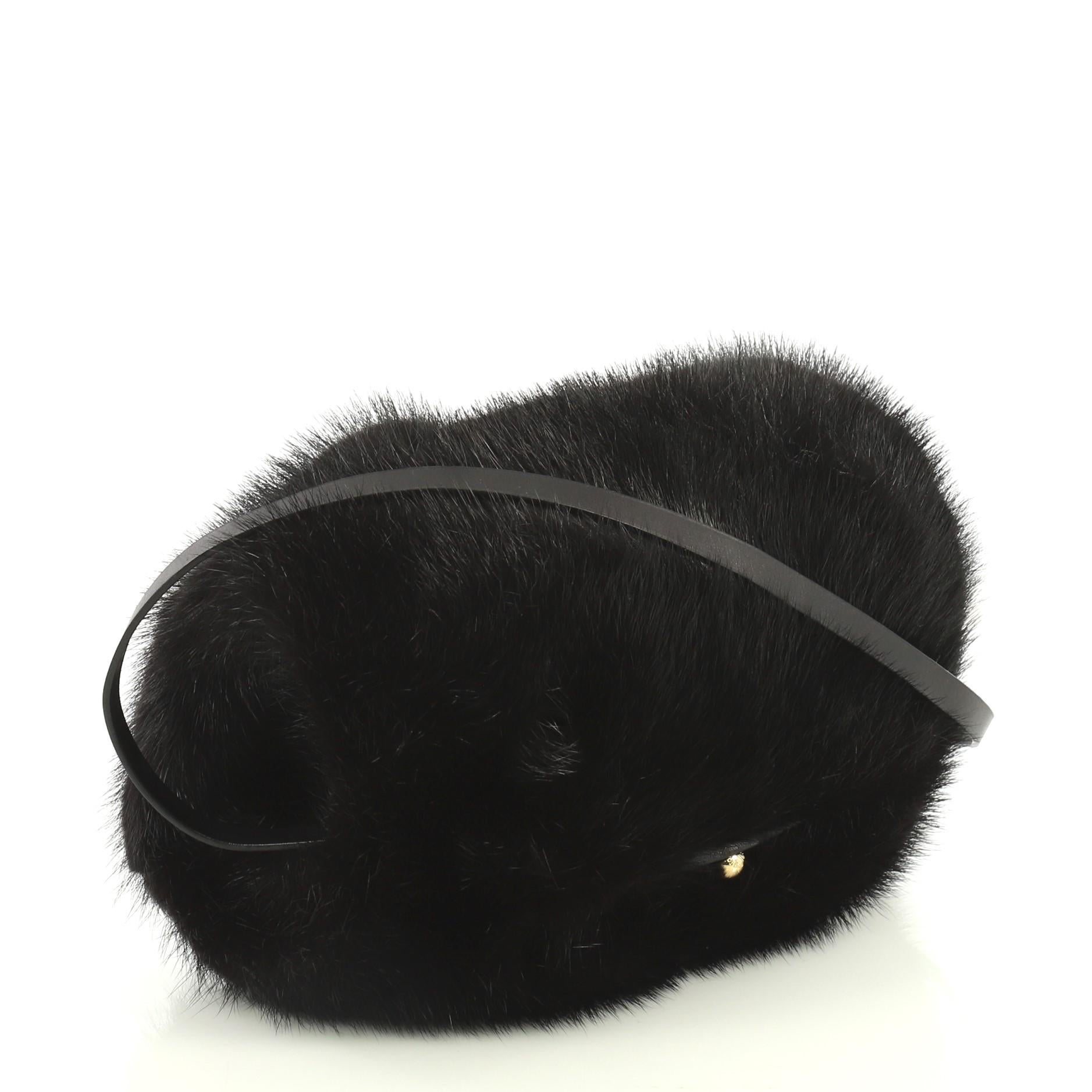 This Louis Vuitton Muff Bag Mink, crafted from black mink, features an adjustable shoulder strap and gold-tone hardware. It opens to a gray fabric interior. This item can only be shipped within the United States.

Estimated Retail Price: