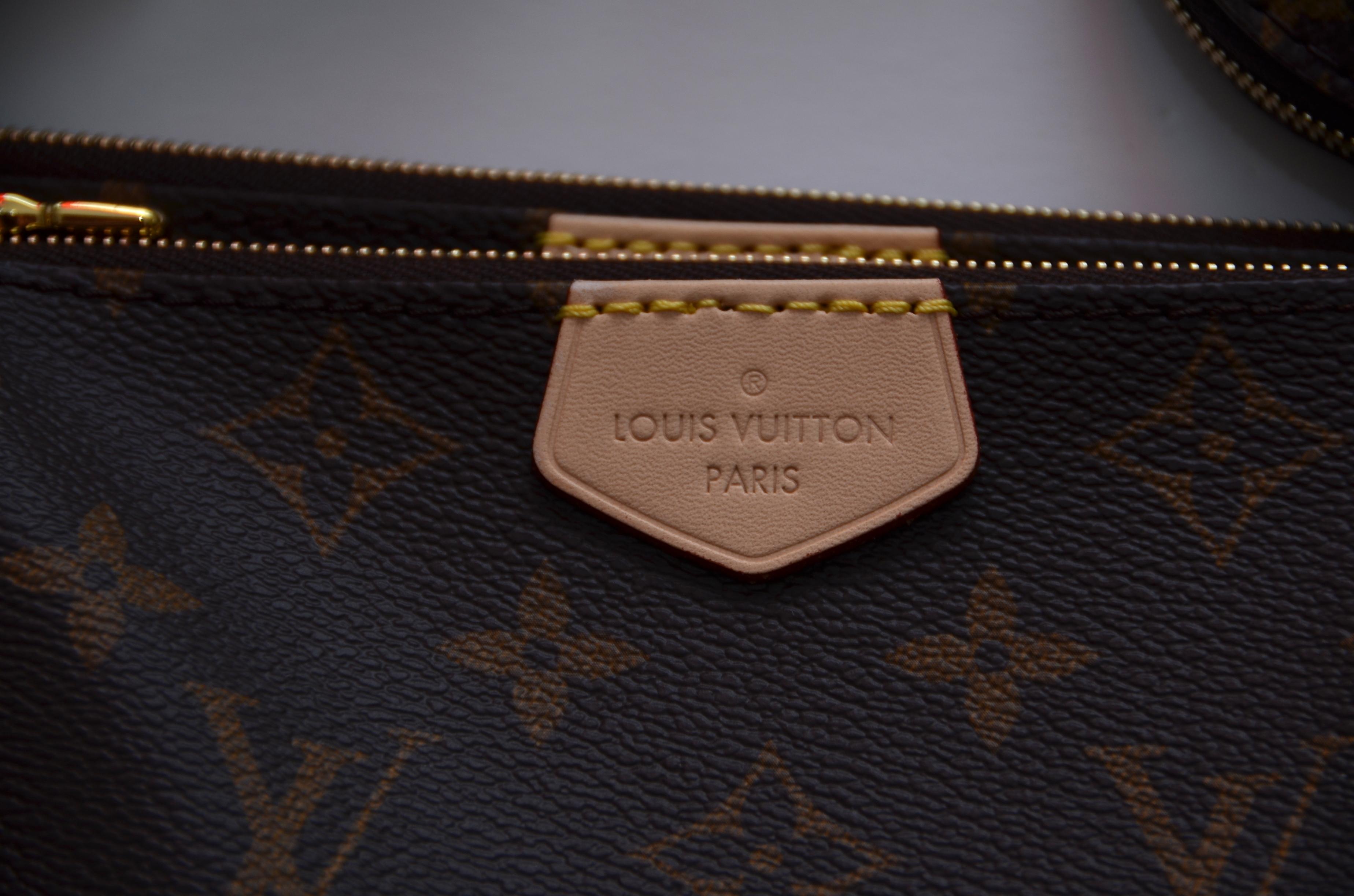 We guarantee this is an authentic LOUIS VUITTON Monogram Multi Pochette Accessories handbag. This chic crossbody bag is crafted of monogram coated canvas and features a removable canvas strap and gold hardware. The top zipper opens to a brown fabric