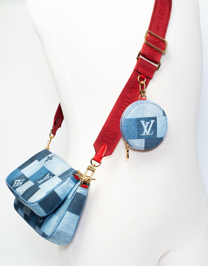 This popular bag by LV is perfect as a crossbody bag for everyday city life. This bag is made of blue denim with gold-tone hardware, red contrasting fabric strap, 2 clip on smaller bags, top zip closure and a blue woven fabric interior.

COLOR: