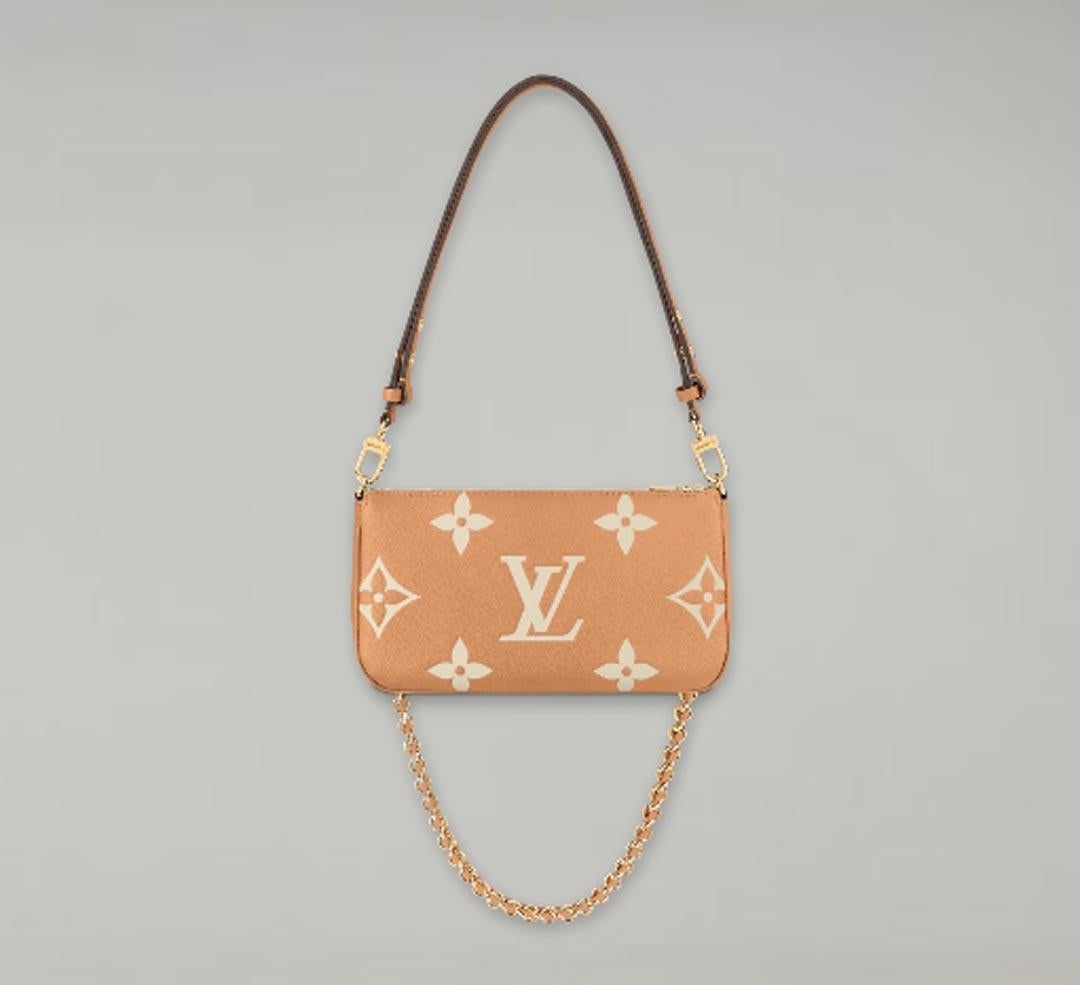 This Multi Pochette Accessories shoulder bag is crafted in Monogram Empreinte leather in a warm two-tone colourway that showcases the Monogram flowers and LV Initials embossed and printed on the cowhide leather. This hybrid piece combines an