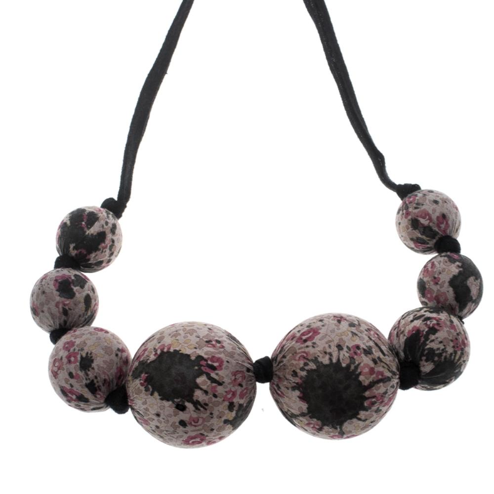 Accessories that are high on style are absolutely worth the buy, such as this Statement necklace by Louis Vuitton. It has been so well crafted with pretty fabric beads in varied sizes while being held by self-tie ribbons. The piece is subtle yet so