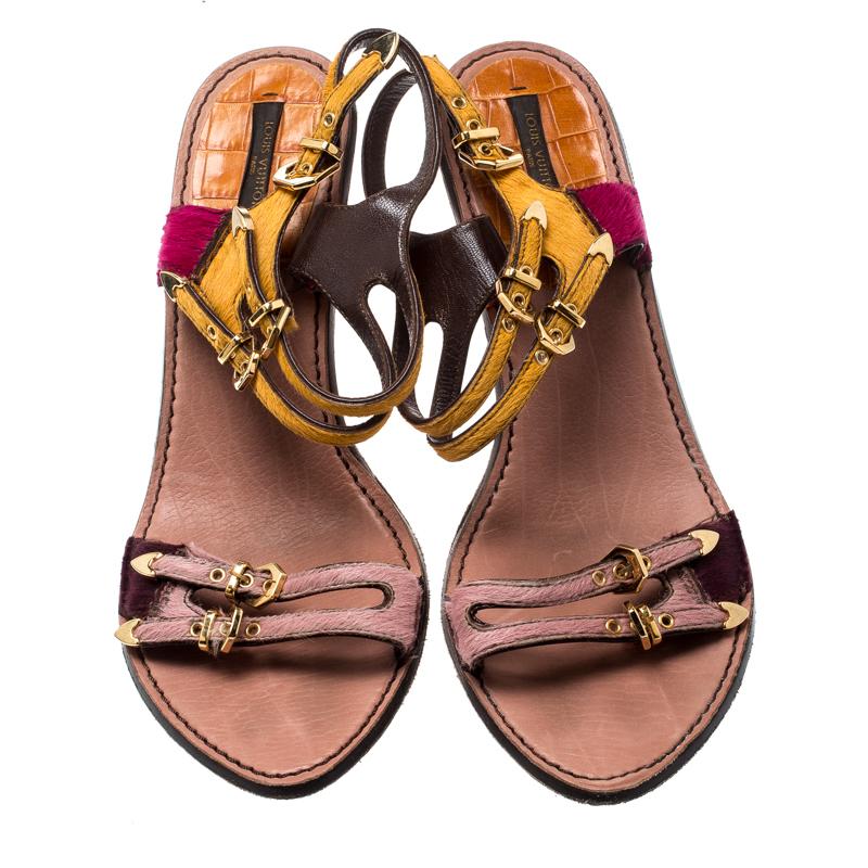 Beauty flows out of these sandals from Louis Vuitton! Wonderfully made, these sandals have calf hair straps in varied colours, multiple buckle detailing and 11 cm heels to help you stand tall. They are gorgeous and highly stylish.

