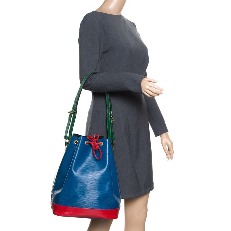 Created in 1932 by Louis Vuitton to carry bottles of Champagne, the iconic Noe now serves as a stylish daytime handbag. Crafted from blue epi leather the bag features red contrasting leather trim and exudes just the right amount of sophistication.