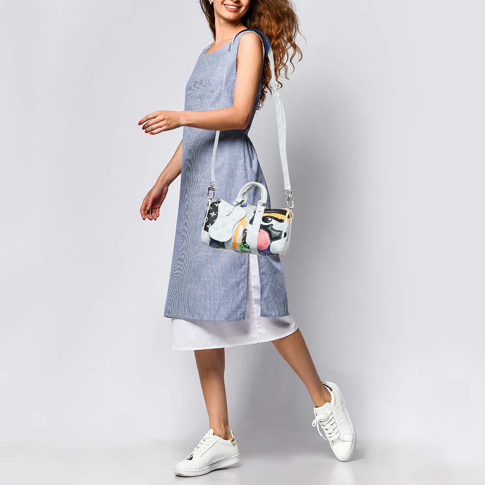 The Louis Vuitton Keepall BandouliÃ¨re 25 Bag from LV Men's Fall 2023 runway offers a compact yet spacious design  blending functionality with iconic style. Crafted in Monogram canvas with vibrant multicolored accents  this versatile bag features a