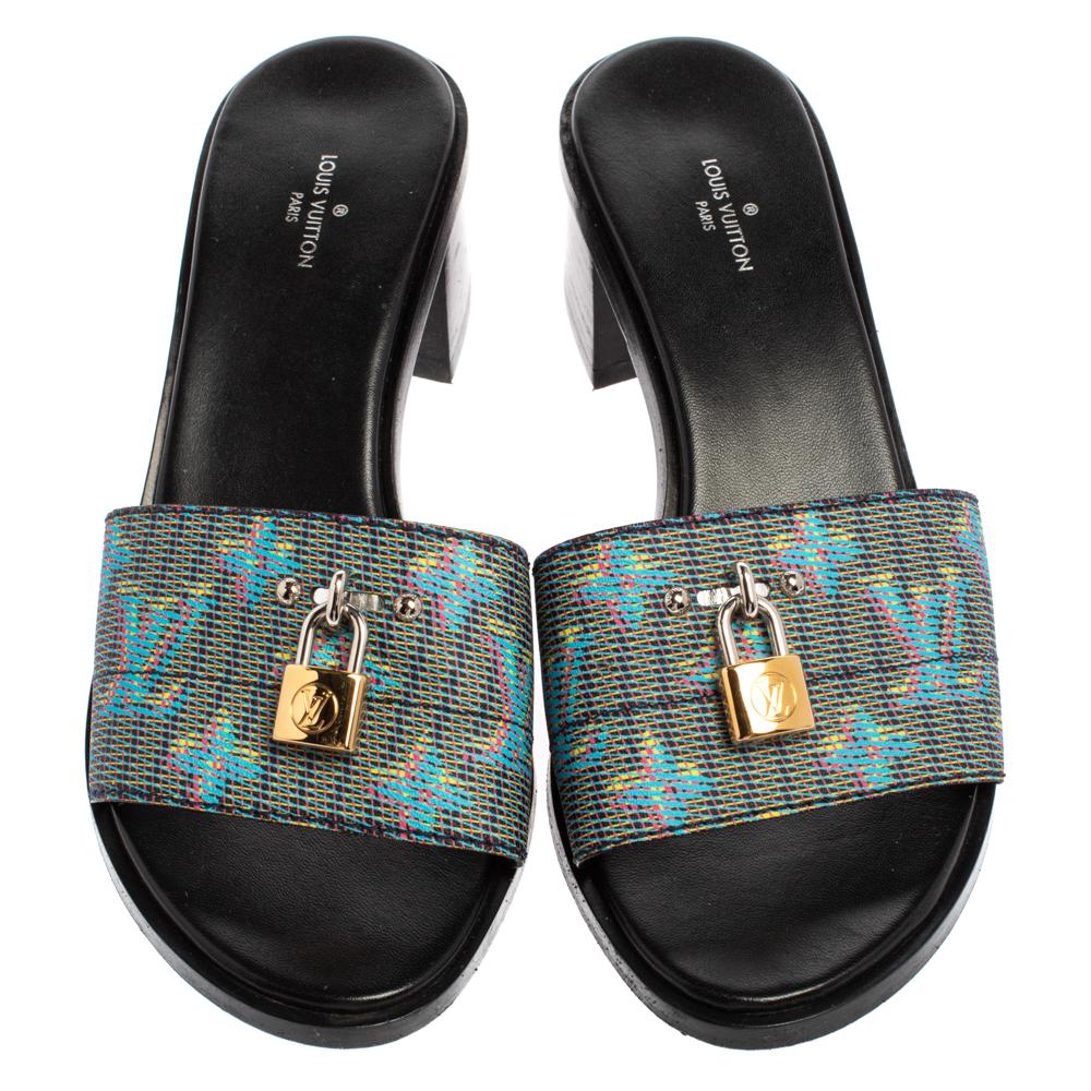 These Lock-It sandals from Louis Vuitton are a gift of comfort and style you cannot refuse! They have been crafted from multicolored monogram coated canvas and styled in an open toe silhouette. The vamps are creatively detailed with a gold-tone LV
