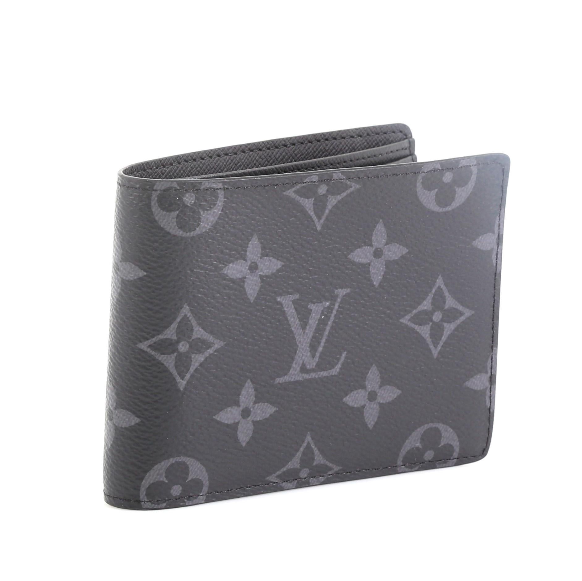 This Louis Vuitton Multiple Wallet Monogram Eclipse Canvas, crafted in black monogram coated canvas. It opens to a black leather interior with multiple card slots. Authenticity code reads: CT1178 

Estimated Retail Price: $490
Condition: Very good.