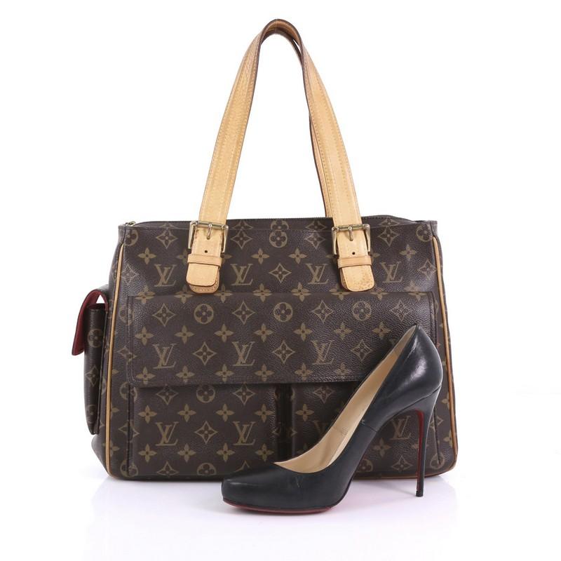 This Louis Vuitton Multipli Cite Handbag Monogram Canvas, crafted from brown monogram coated canvas, features dual flat vachetta leather straps with buckle details, two exterior front flap pockets, exterior side flap pocket, and gold-tone hardware.