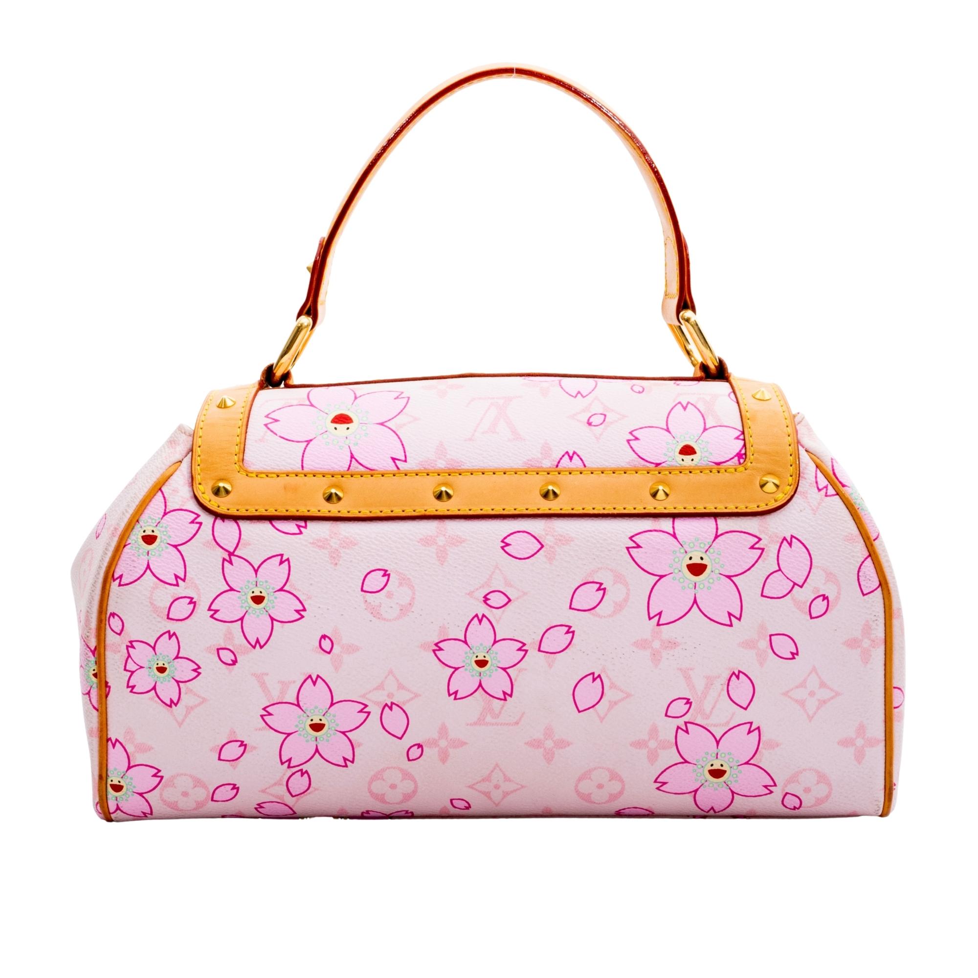 From the Takashi Murakami Collection. This is a pink tonal monogram coated canvas Louis Vuitton Cherry Blossom Sac Retro with brass hardware, tan vachetta leather trim, single flat top handle, conical stud embellishments throughout, tan vachetta
