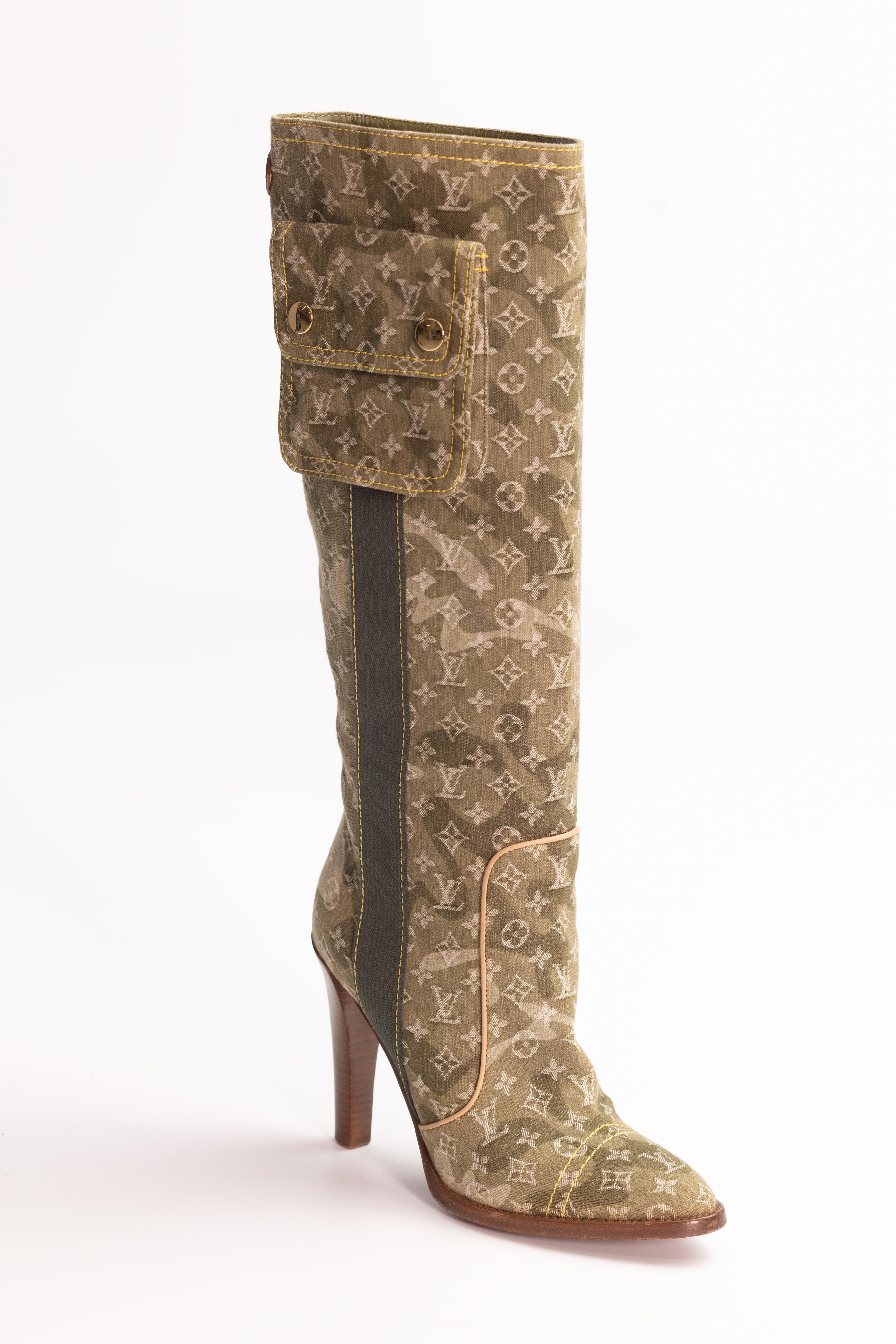 Olive green denim Louis Vuitton knee-high boots are made with lichen green Louis Vuitton monogram denim and feature Murakami monogramouflage print, round toes, tonal stitching, lasticized gore at sides featuring flap pocket, gold-tone logo adornment