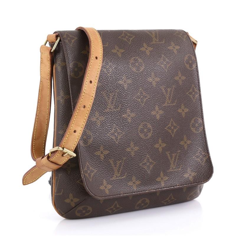 This Louis Vuitton Musette Salsa Handbag Monogram Canvas PM, crafted from brown monogram coated canvas, features adjustable cowhide leather strap, full frontal flap, and gold-tone hardware. Its snap closure opens to a brown microfiber interior with