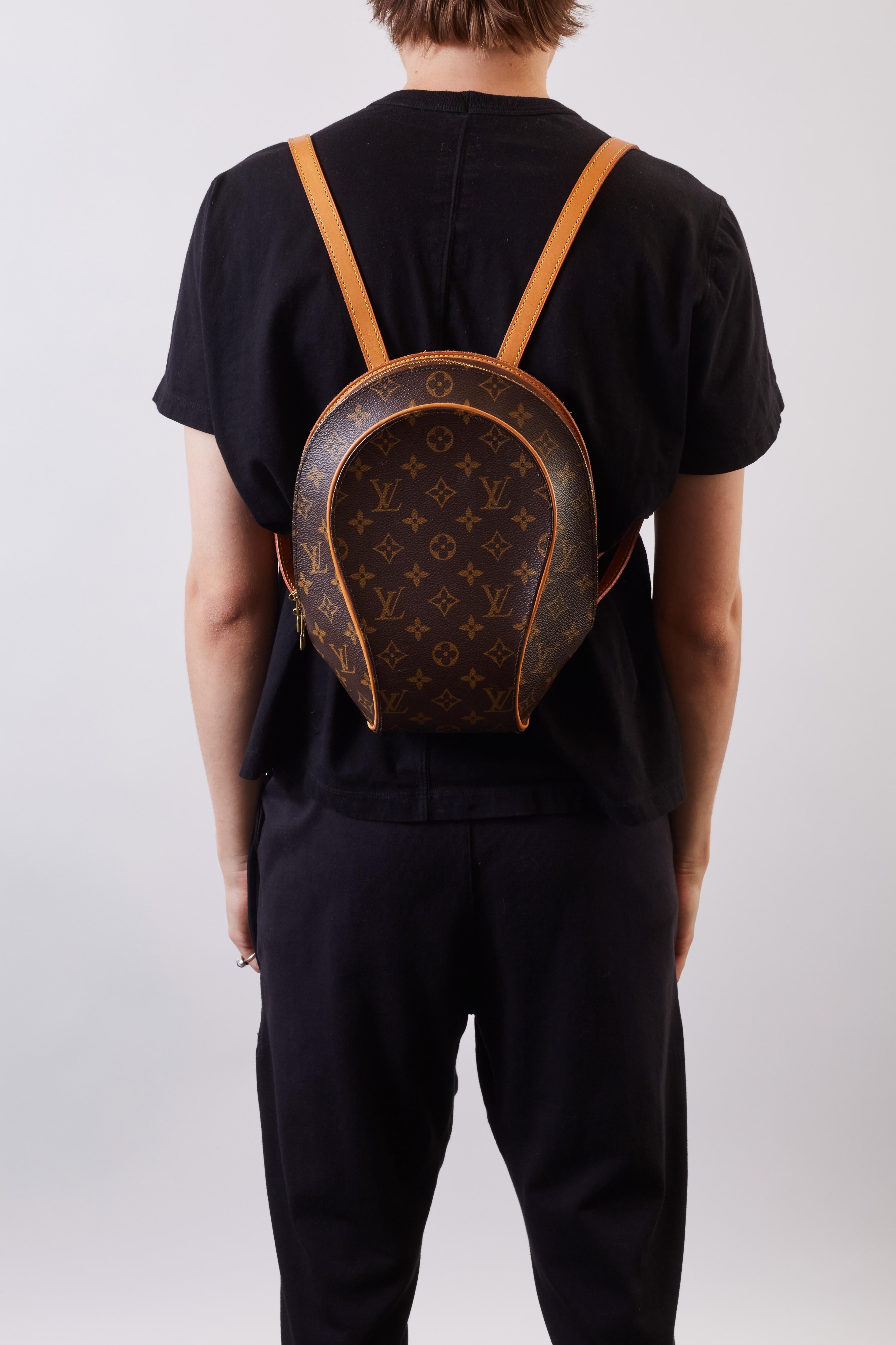This backpack is made of classic Louis Vuitton monogram coated canvas with signature vachetta natural cowhide trim and adjustable shoulder straps for structure and style. There is a brass wrap-around zipper that opens to an interior of cocoa brown