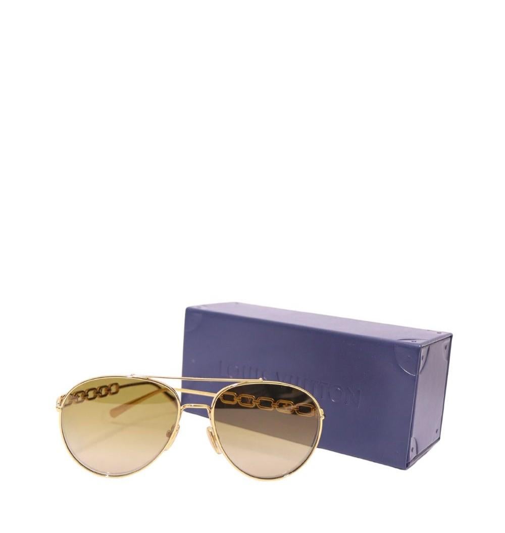 Louis Vuitton My LV Chain Pilot Sonnenbrille, mit getönten, braunen Gläsern mit Farbverlauf, goldenem Metall, Monogrammsymbol-Ausschnitten und geraden Bügeln mit abgewinkelten Spitzen.

Hardware: Metall
Linse: Braun
Breite des Objektivs: 58