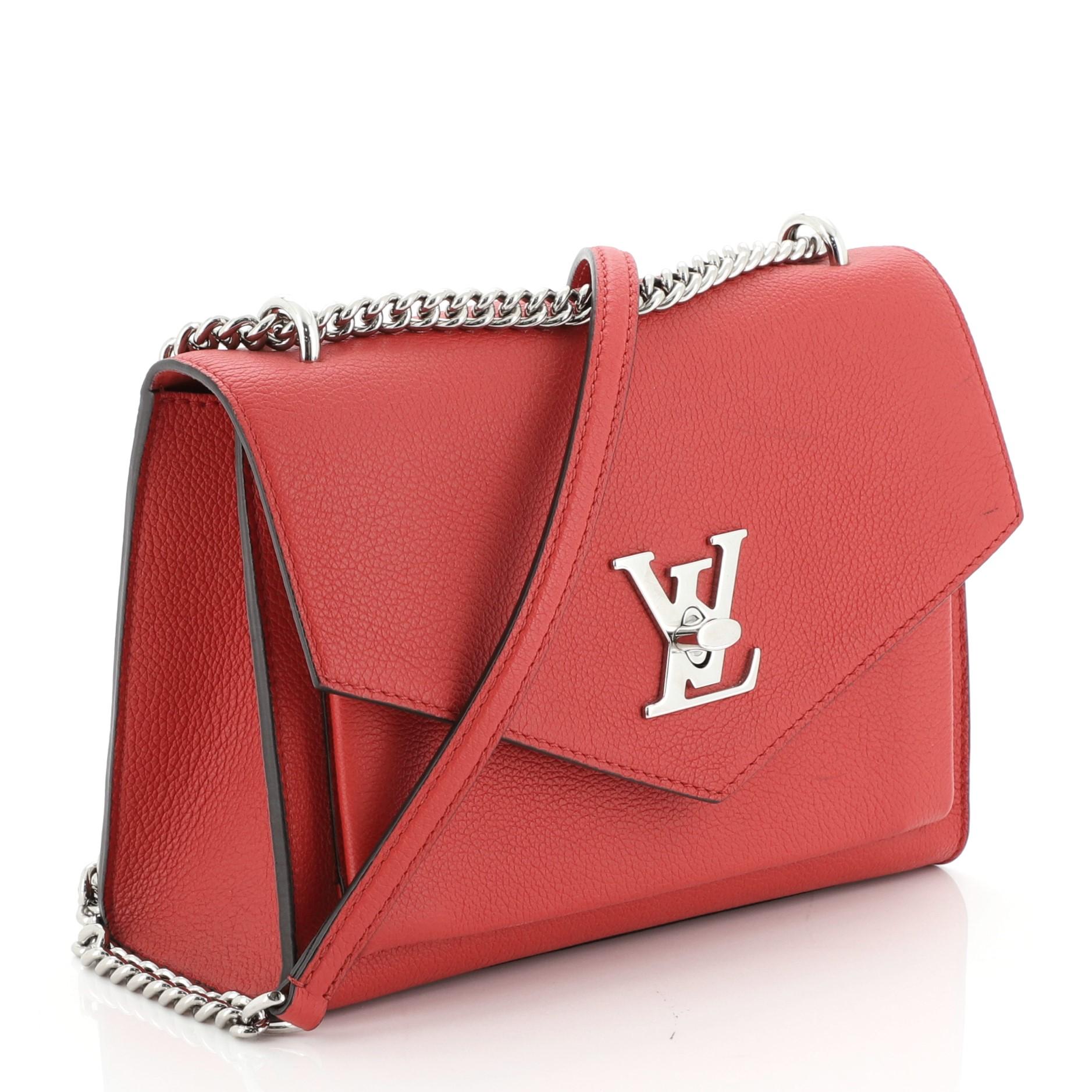 This Louis Vuitton Mylockme Handbag Leather BB, crafted in red leather, features chain link strap with leather pad, exterior back zip pocket, slip pocket under flap, and silver-tone hardware. Its LV twist-lock closure opens to a red microfiber