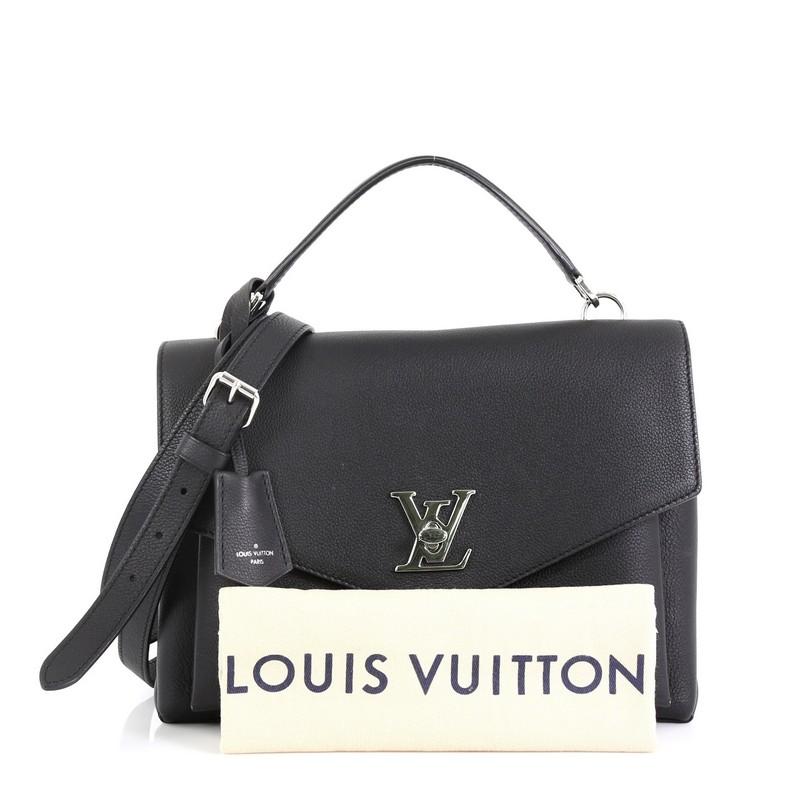 This Louis Vuitton Mylockme Handbag Leather, crafted in black leather, features a leather top handle, exterior back zip pocket, and silver-tone hardware. Its LV twist-lock closure opens to a black microfiber interior divided into two compartments