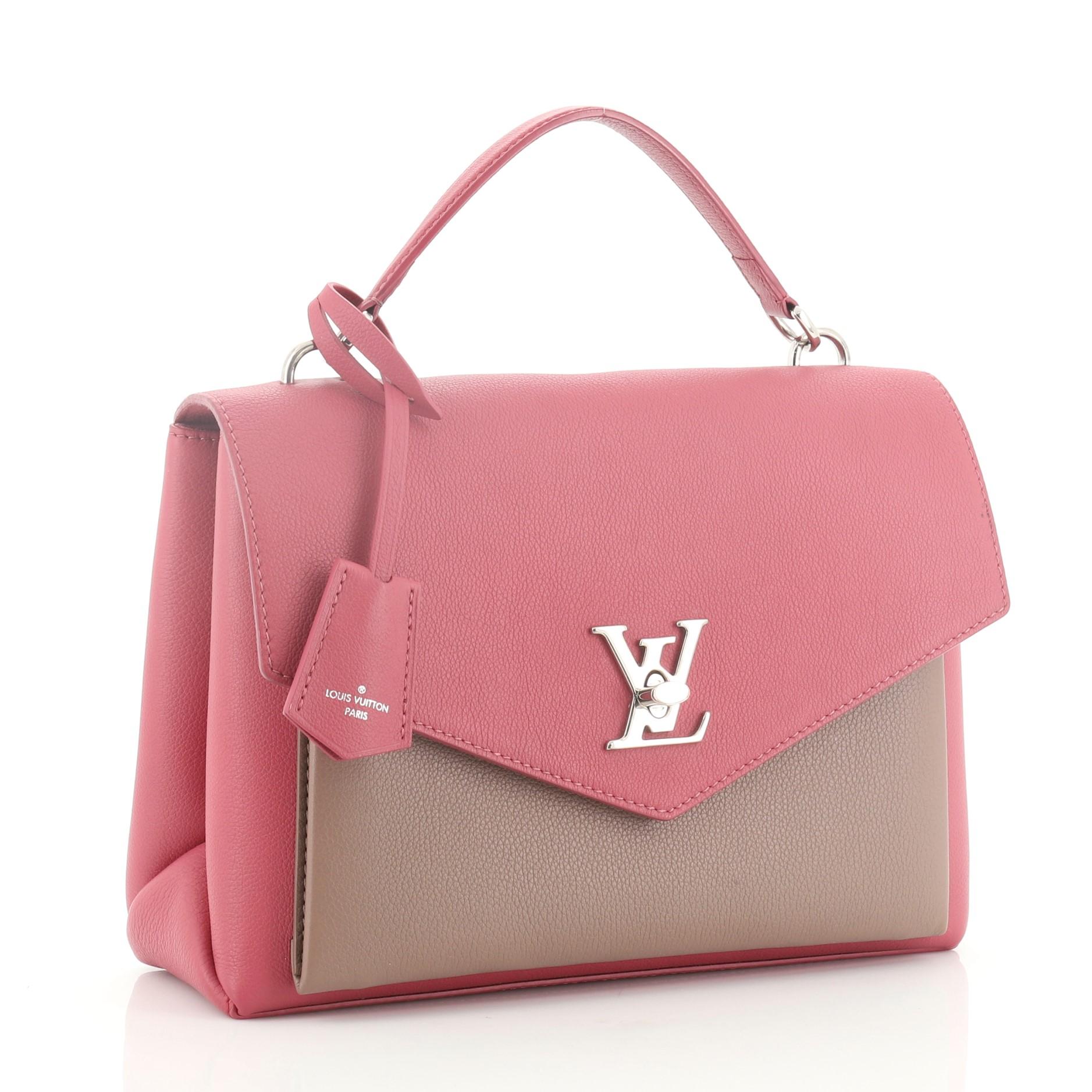This Louis Vuitton Mylockme Handbag Leather, crafted in pink and neutral leather, features a leather top handle, exterior back zip pocket, and silver-tone hardware. Its LV twist-lock closure opens to a pink microfiber interior divided into two