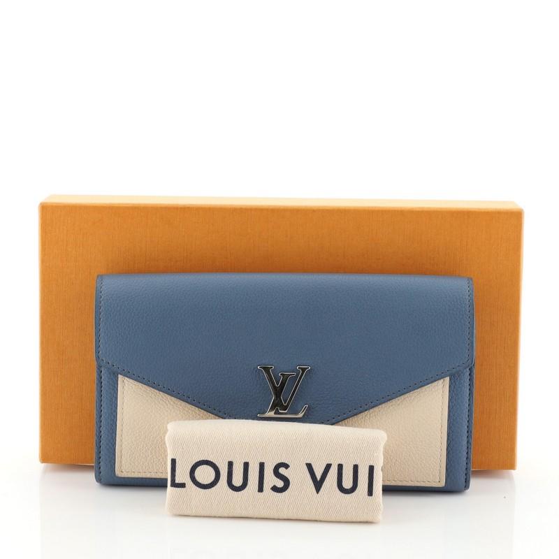This Louis Vuitton Mylockme Wallet Leather, crafted in blue and neutral leather, features silver-tone hardware. Its LV twist-lock closure opens to a blue leather interior with multiple card slots, middle zip pocket and slip pocket. Authenticity code