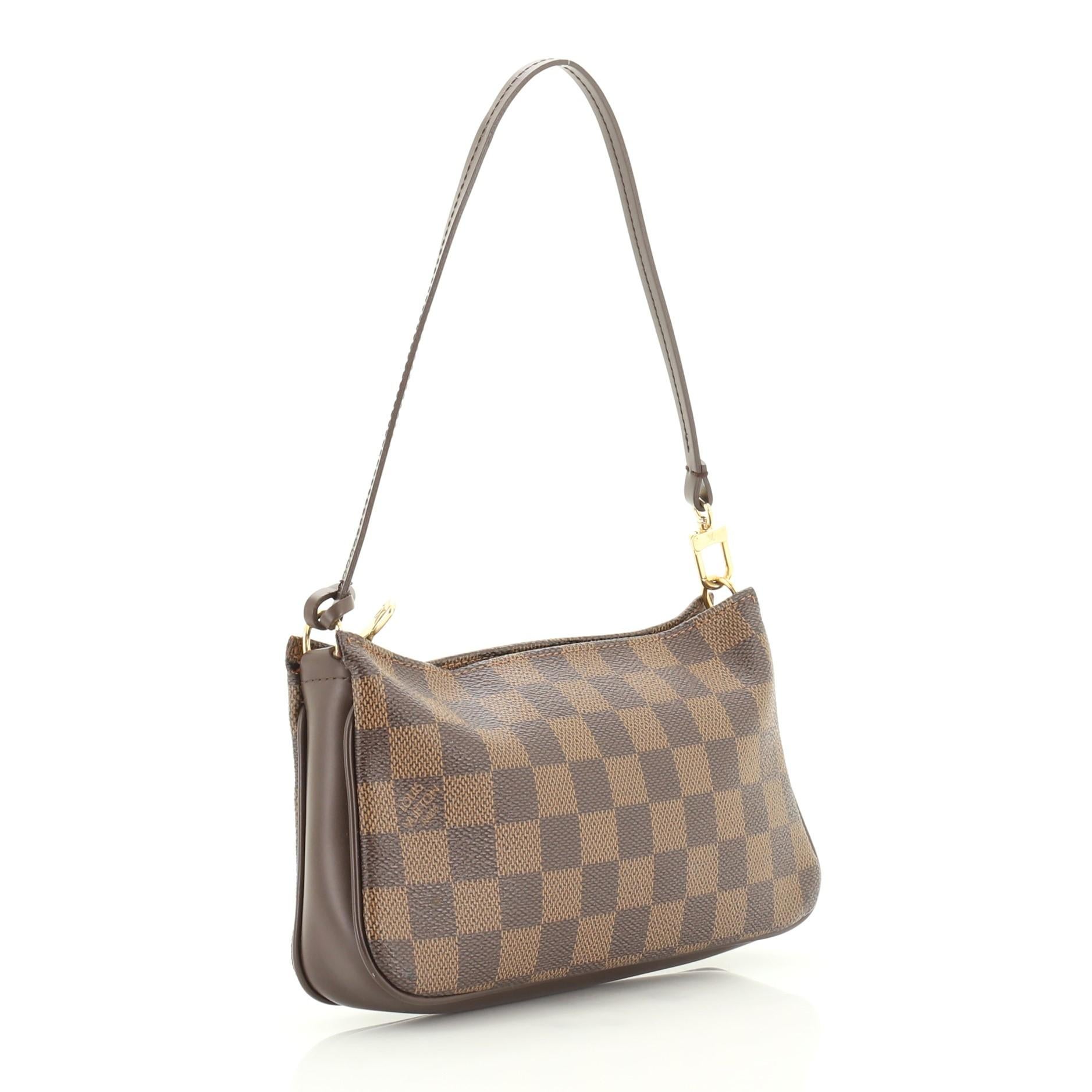 This Louis Vuitton Navona Pochette Accessoires Damier, crafted from damier ebene coated canvas, features a flat leather strap and gold-tone hardware. Its zip closure opens to an orange fabric interior. Authenticity code reads: FL0035. 

Condition: