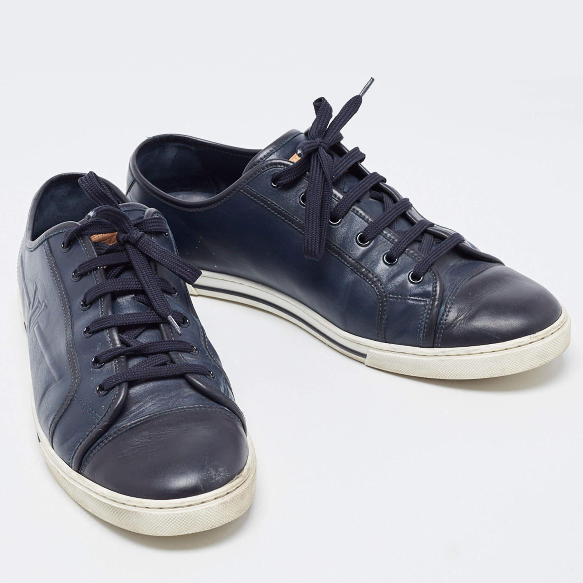 Experience footwear ease with this pair of navy blue low-top sneakers by Louis Vuitton. They've been crafted from leather and detailed with lace closure on the uppers. The leather insoles add to the comfort of the pair.

