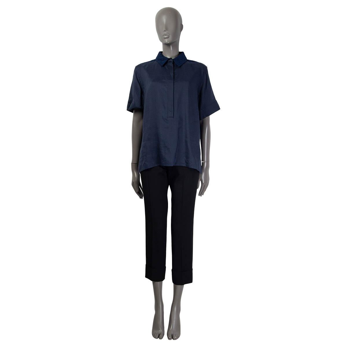 100% authentic Louis Vuitton short sleeve blouse in navy blue ramie (100%). Features broderie anglaise at the back and buttoned cuffs. Opens with six buttons on the front. Unlined. Has been worn once and is in virtually new condition.

Resort 2013