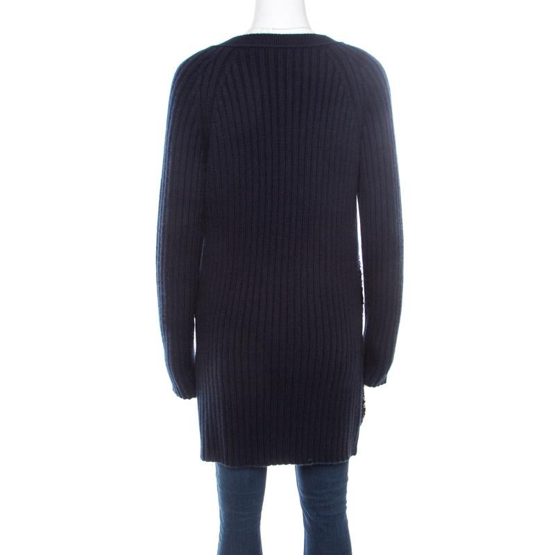 From Louis Vuitton's clothing line comes this wonderful cardigan made from cashmere which is a prized form of wool. It is styled with front buttons, long sleeves and sequin embellishments on the front. The navy blue cardigan will be an ideal