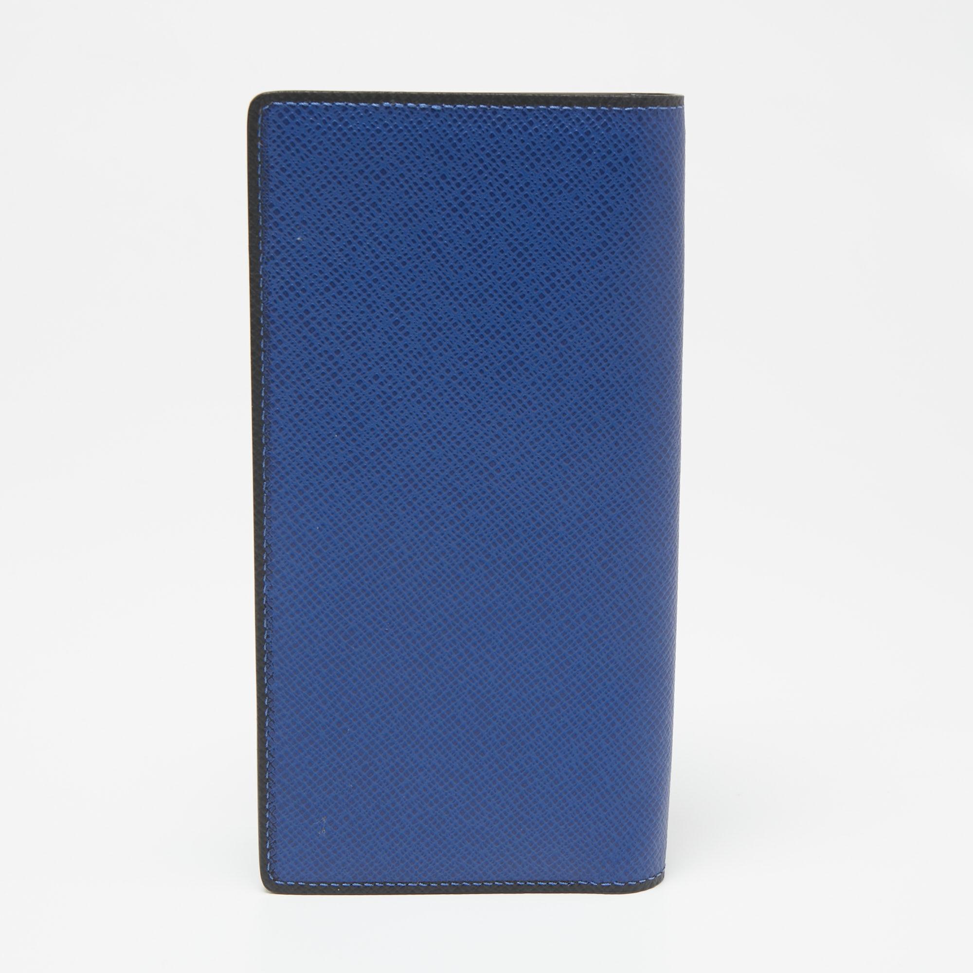 This Brazza wallet from the House of Louis Vuitton is a stylish and functional accessory. It is crafted using navy blue Taiga leather and has a well-lined interior offering multiple storage alternatives. This LV wallet is a great pick to store your