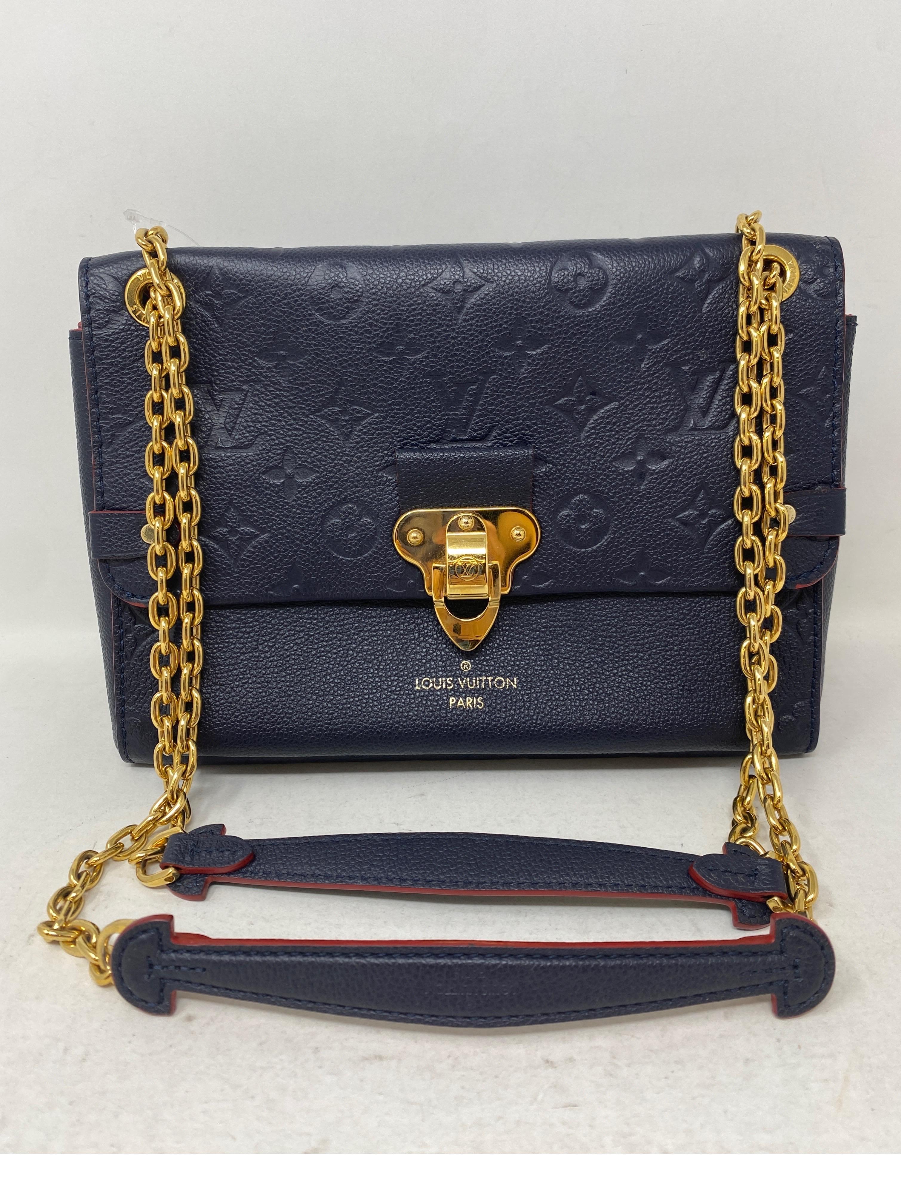 Louis Vuitton Navy Eimpreinte Leather Crossbody Bag. Good condition. Gold hardware. Great crossbody bag or can be doubled as a handbag. Nice clean red interior. Guaranteed authentic. 