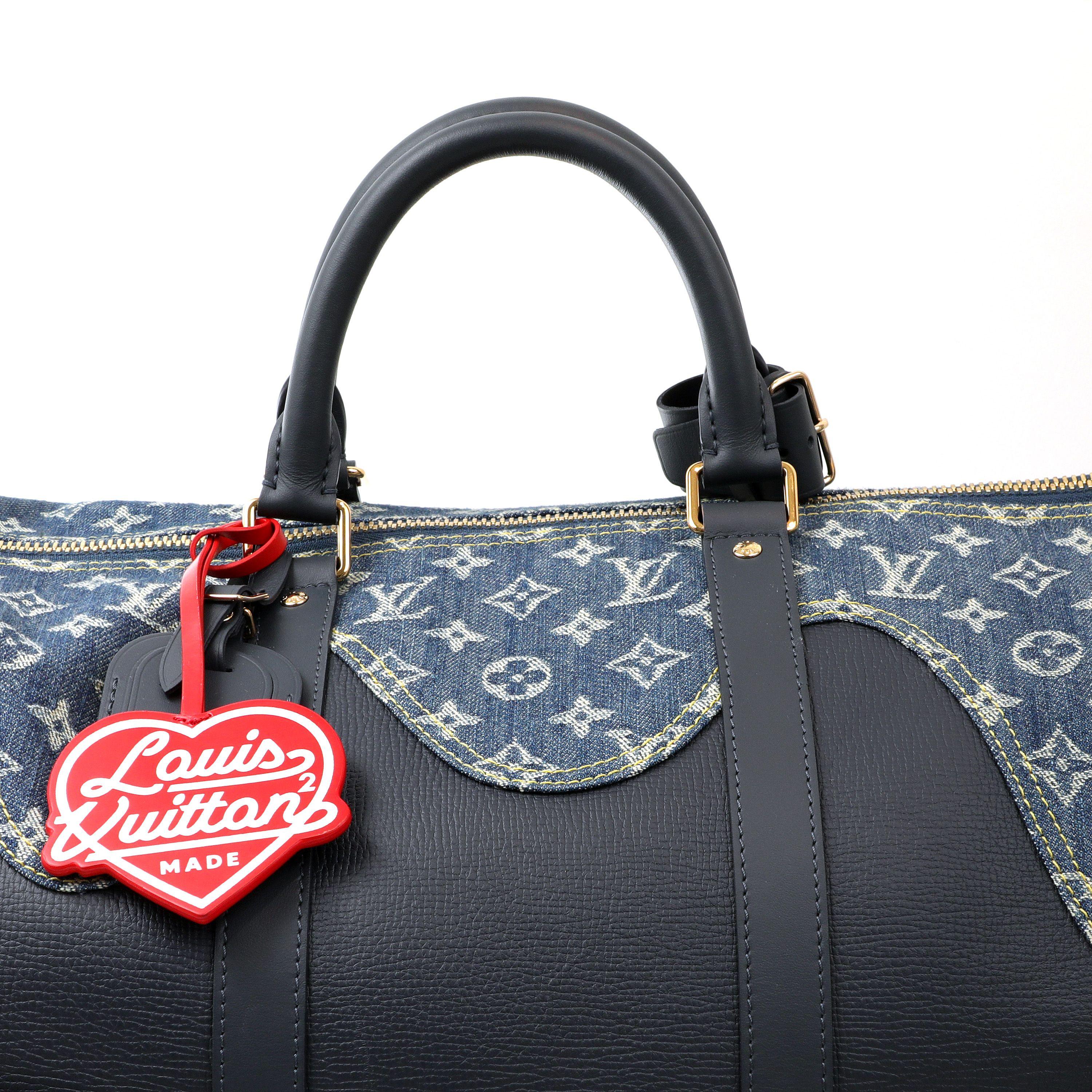 This authentic Louis Vuitton Navy Leather and Denim Monogram Drip Keepall 60 is in pristine condition.  From the Virgil Abloh Collection, this is the largest size of the Bandouliere Keepall.  Navy blue grained leather with LV monogram denim