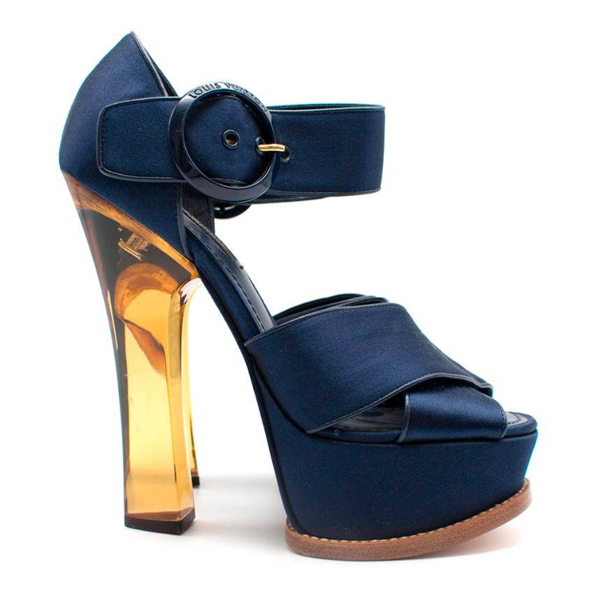Louis Vuitton Navy Satin Florida Platform Sandal  


These stylish ankle strap sandals feature platforms with wide royal blue satin straps, blunt toes, and six-inch yellow plexiglass acrylic sculpted heels.


Material: Satin, Plexiglass, Leather