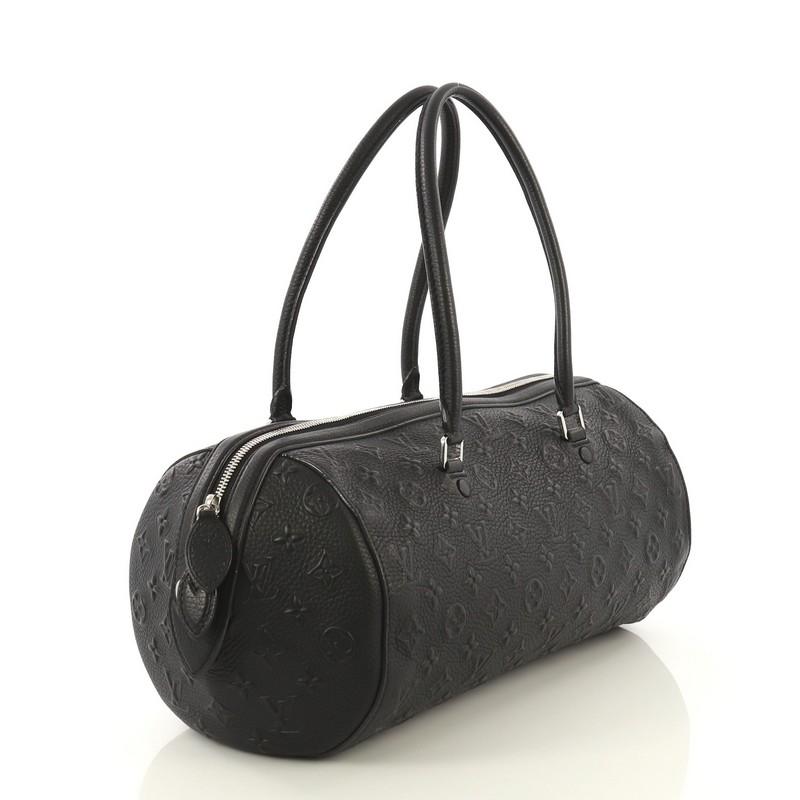 This Louis Vuitton Neo Papillon Handbag Monogram Revelation GM, crafted in black monogram leather, features dual rolled leather handles and silver-tone hardware. Its zip closure opens to a black microfiber interior with slip pocket. Authenticity