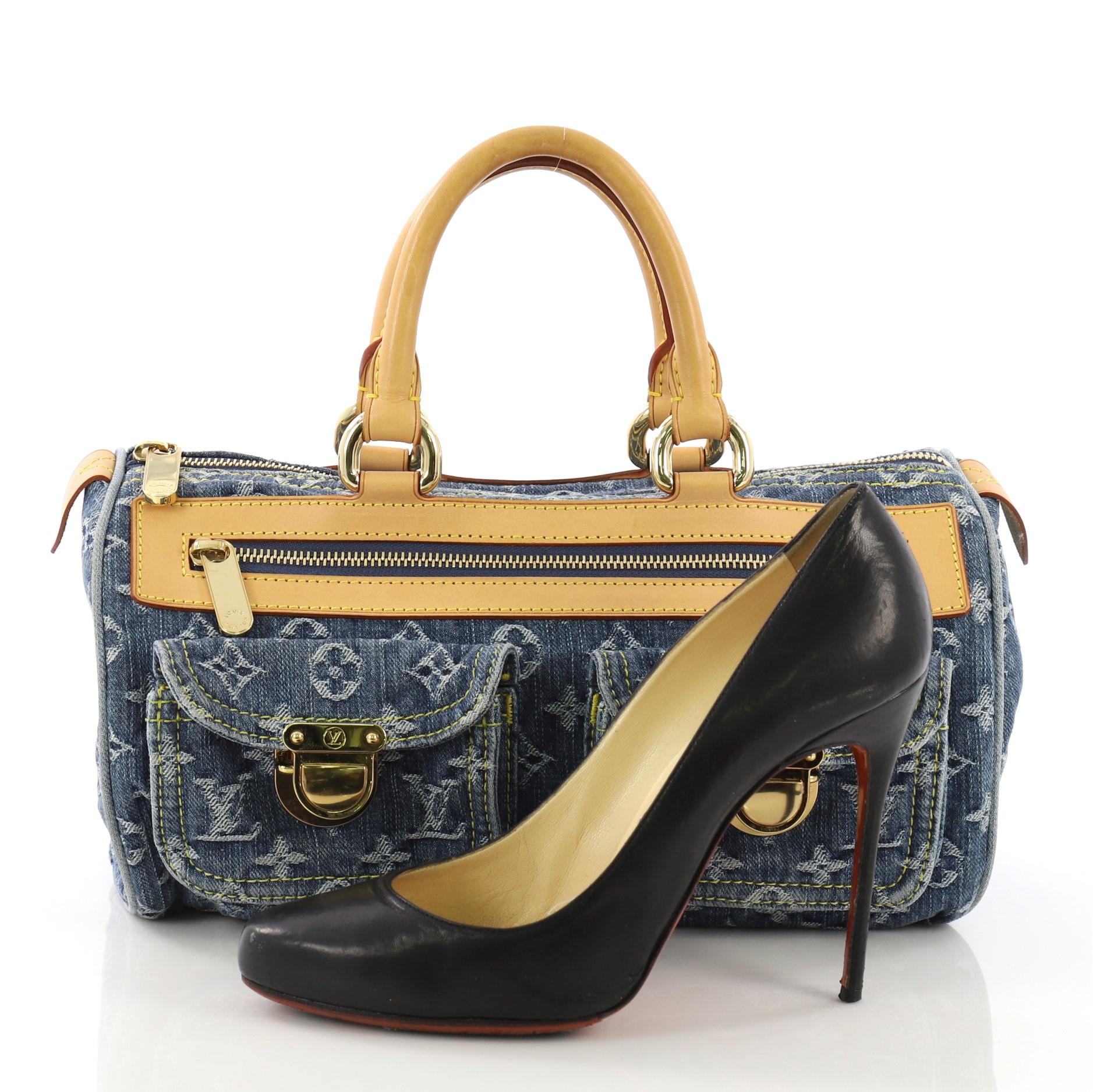 This Louis Vuitton Neo Speedy Bag Denim, crafted in blue denim, features dual rolled cowhide leather handles and trim, front zip compartment, two small front pockets with press lock closure, and gold-tone hardware. Its top zip closure opens to a