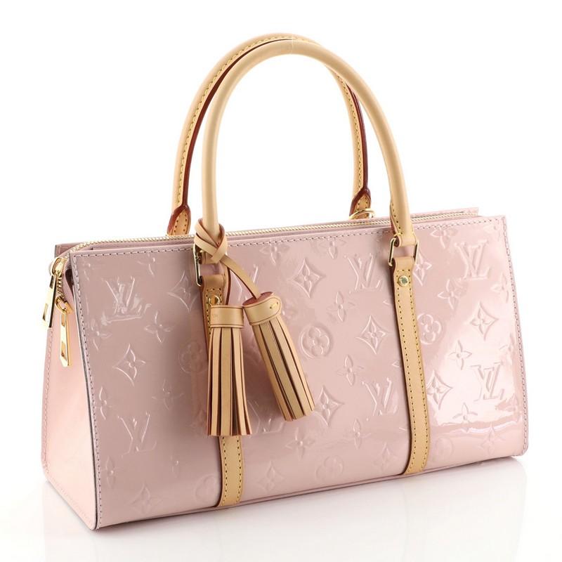 This Louis Vuitton Neo Triangle Handbag Vernis, crafted in pink vernis, features dual rolled handles and gold-tone hardware. Its zip closure opens to a pink microfiber interior. Authenticity code reads: AA0128. 

Estimated Retail Price: