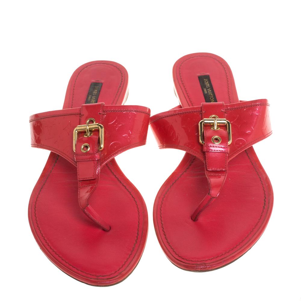 This sandal by Louis Vuitton will be loved for its totally vacation-appropriate plus fun summery design. The pair here is cut in neon pink monogram patent leather, set on a cushioned insole, and finished off with a buckle detail in gleaming