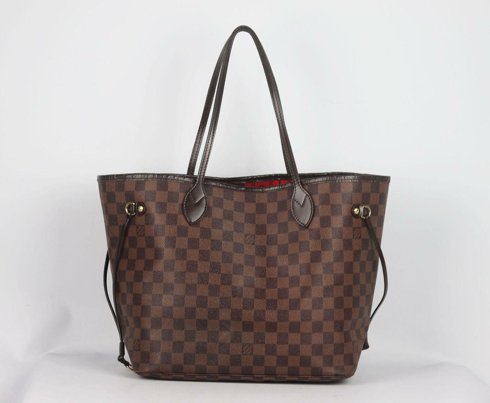 Louis Vuitton's classic 'Neverfall' bag in brown and beige Damier Ebène coated-canvas with leather accents, this 'MM' structured style has a spacious compartment lined in the brand's iconic red striped canvas with internal clip to attach your items