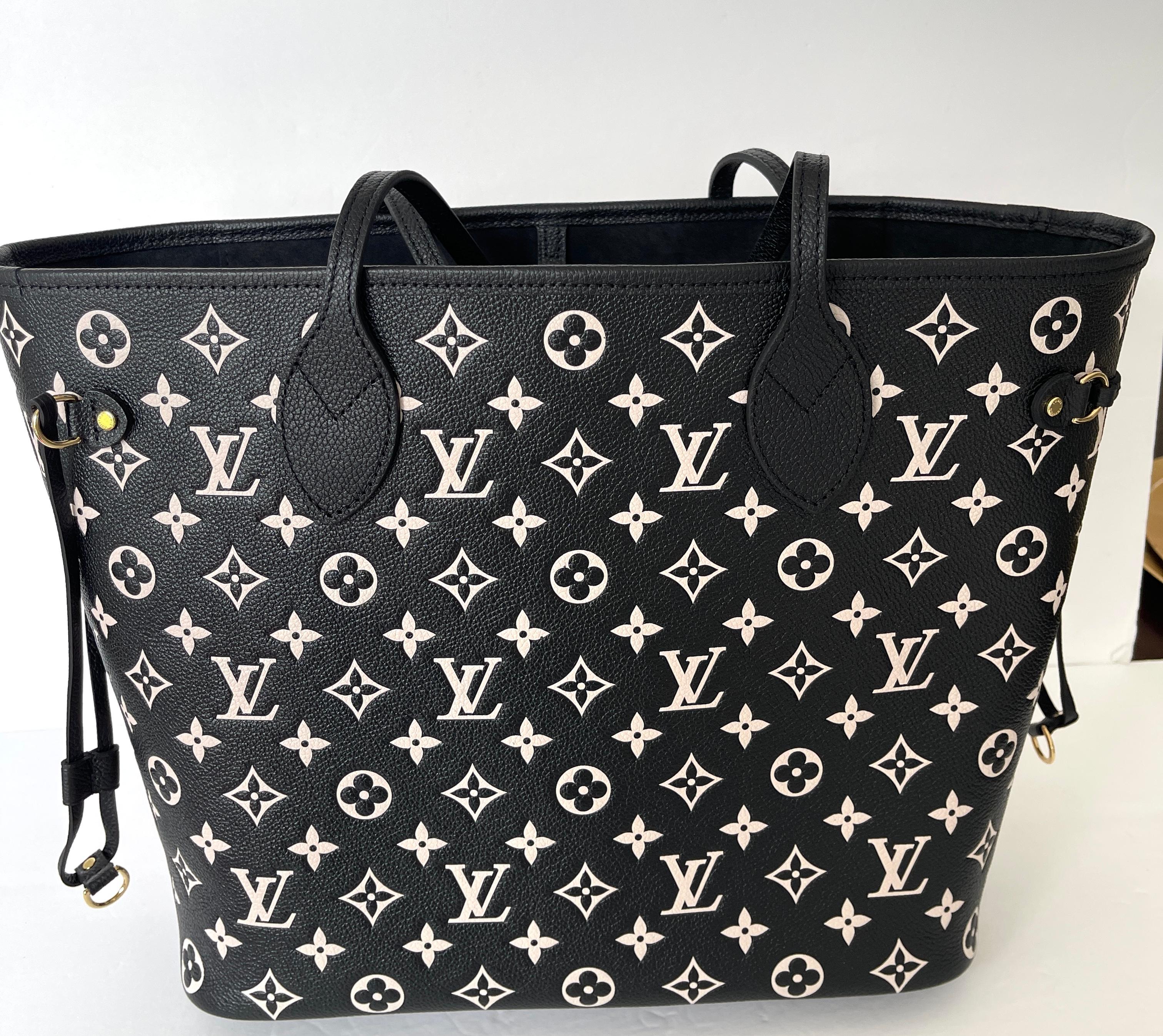 Louis Vuitton Neverfull
SOLDOUT AT LV
Done in Empriente Leather, unlike the canvas editions
Empriente  Monogram Neverfull
A must for the avid collector
The Neverfull MM Size
Black White and Pink Pouch
Style number M46103
12.2 x 11 x 5.5