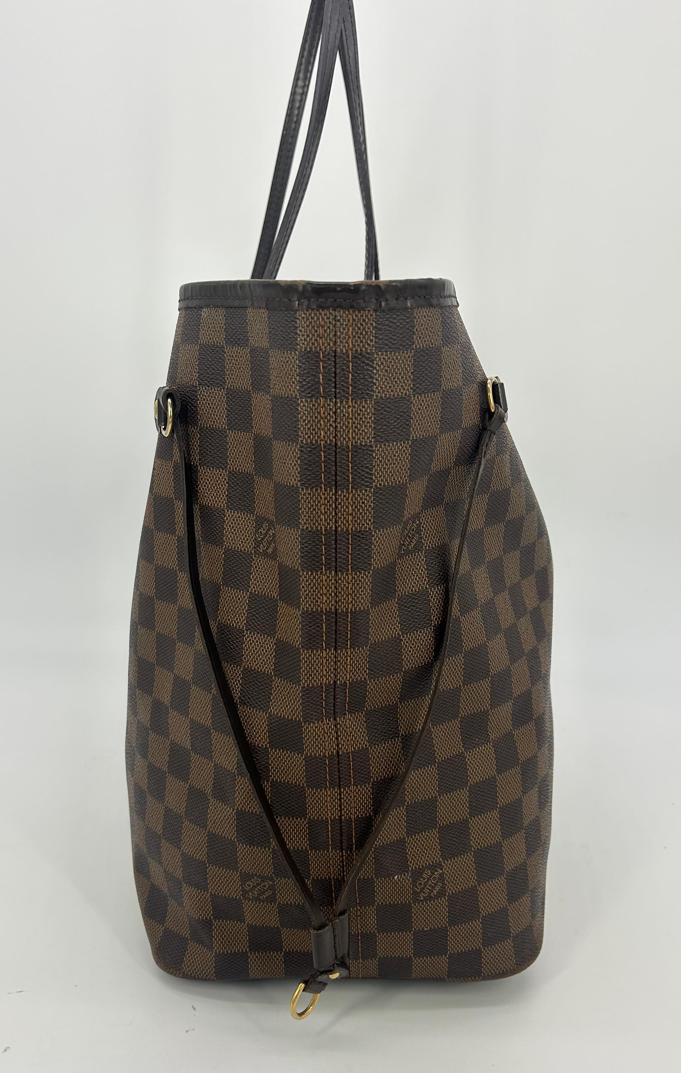 Louis Vuitton Neverfull GM Damiere Ebene In fair condition. Signature brown and dark brown checkered Damiere Ebene coated canvas exterior with dark brown leather handles and trim. Top gold buckle closure opens to red and black striped canvas