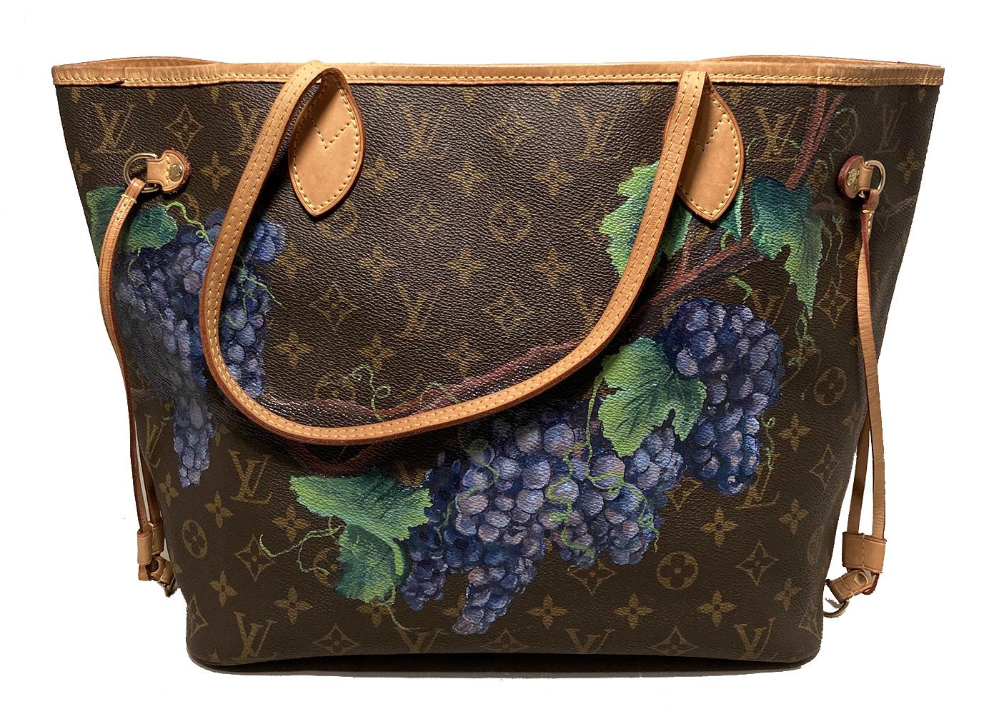 Louis Vuitton Neverfull MM with Hand Painted Grapes in very good condition. Signature monogram canvas exterior trimmed with tan leather, brass hardware, and hand painted grapes and grape leaves along front and back sides. Top spring ring closure