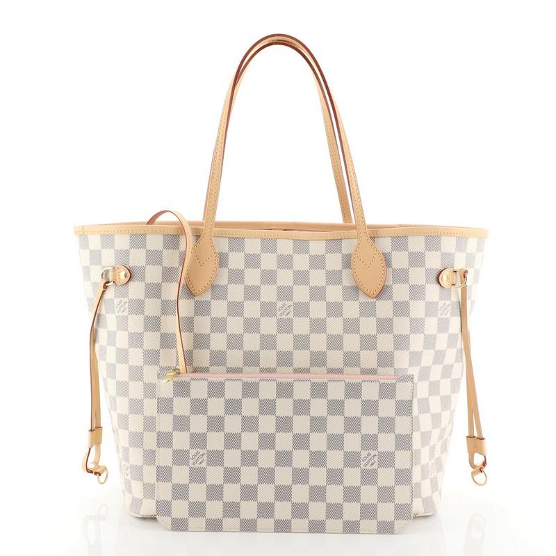 This Louis Vuitton Neverfull NM Tote Damier MM, crafted in damier azur coated canvas, features dual slim leather handles, side laces and gold-tone hardware. Its wide open top showcases a pink fabric interior with side zip pocket. Authenticity code